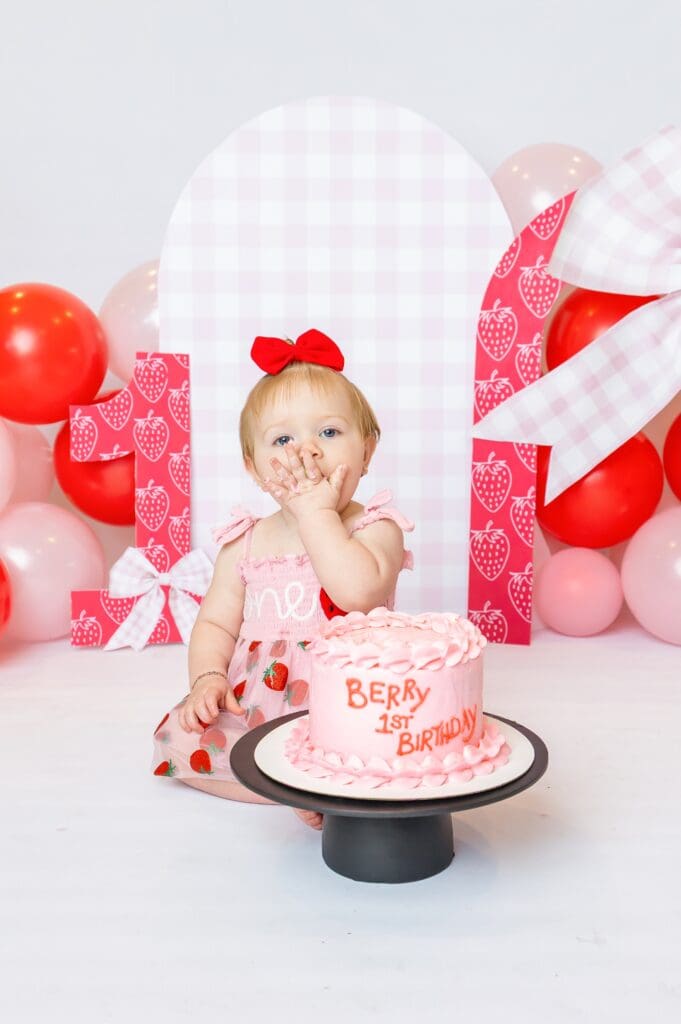 Studio-style first birthday photography in Pittsburg, KS featuring a personalized backdrop