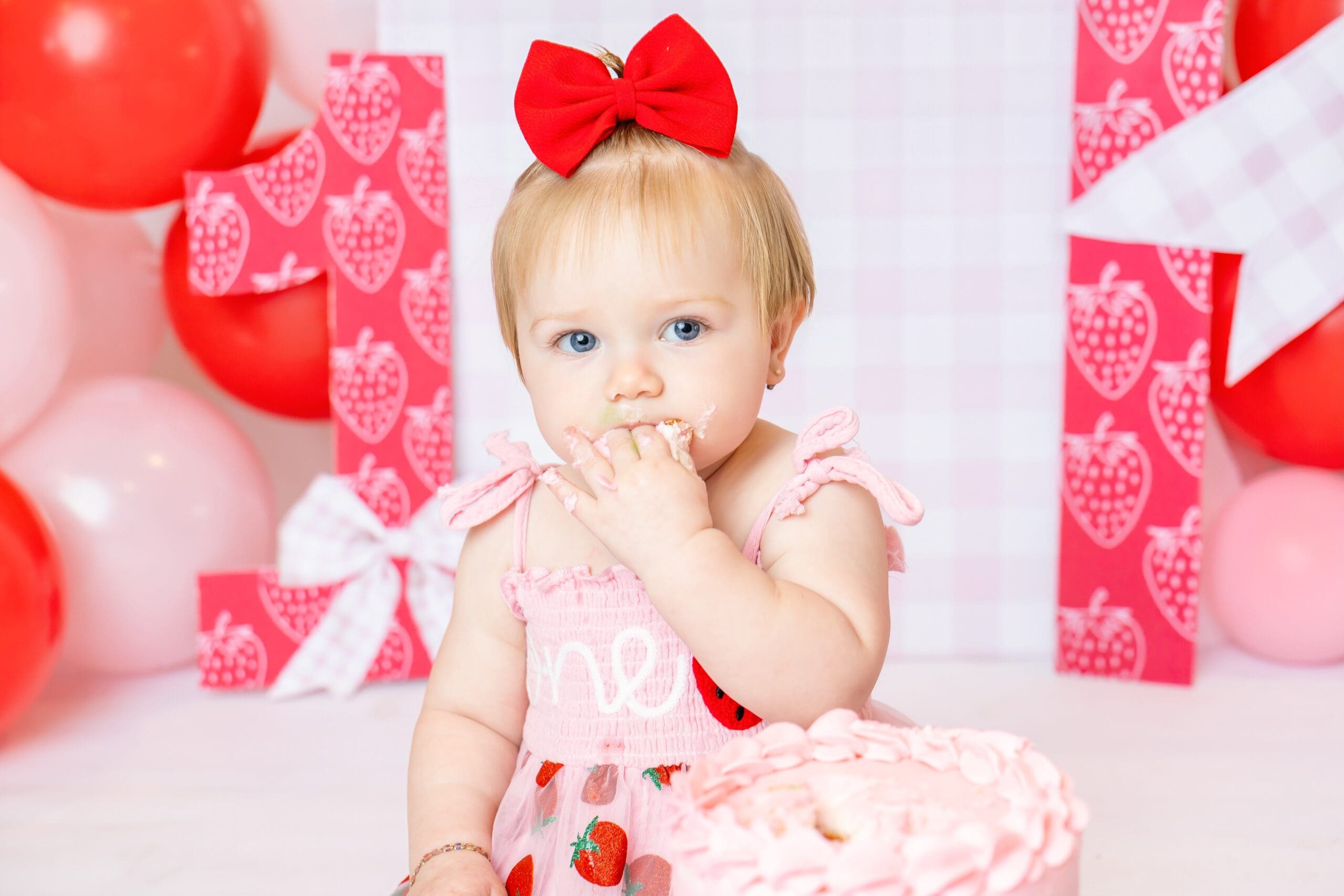 One-year-old girl enjoying her personalized first birthday photoshoot