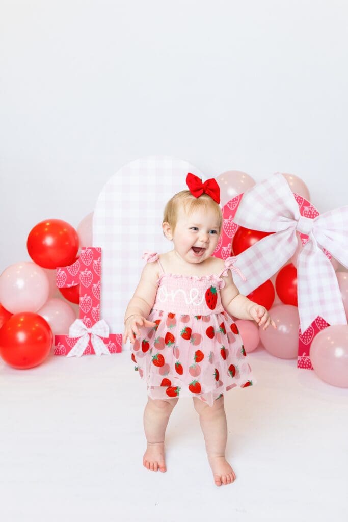 Stella celebrating her first birthday during a custom milestone photoshoot in Pittsburg, Kansas