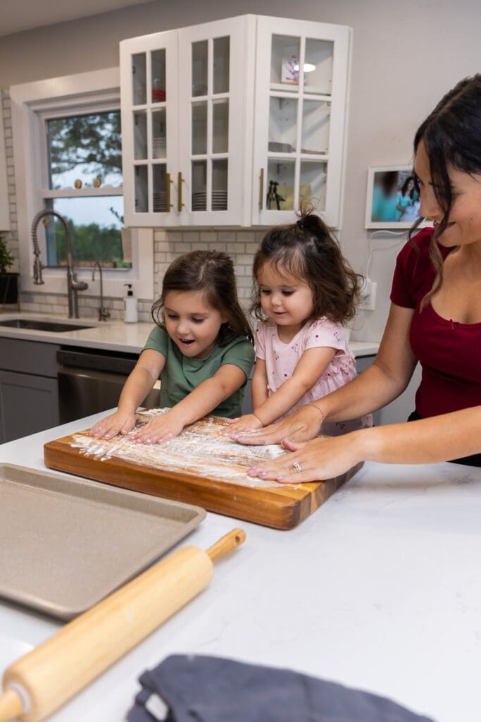 family getting messy during an in home fun baking photoshoot session in pittsburg ks
