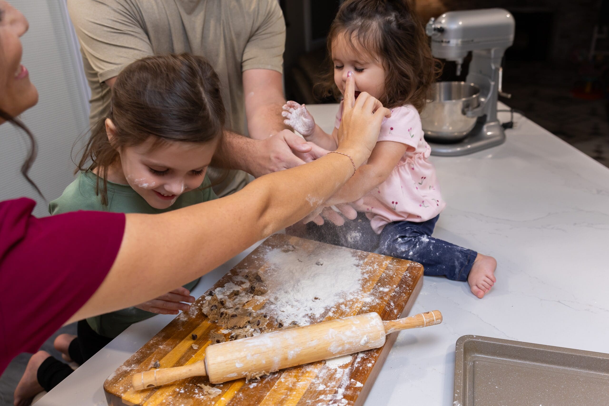 family getting messy during an in home fun baking photoshoot session in joplin mo