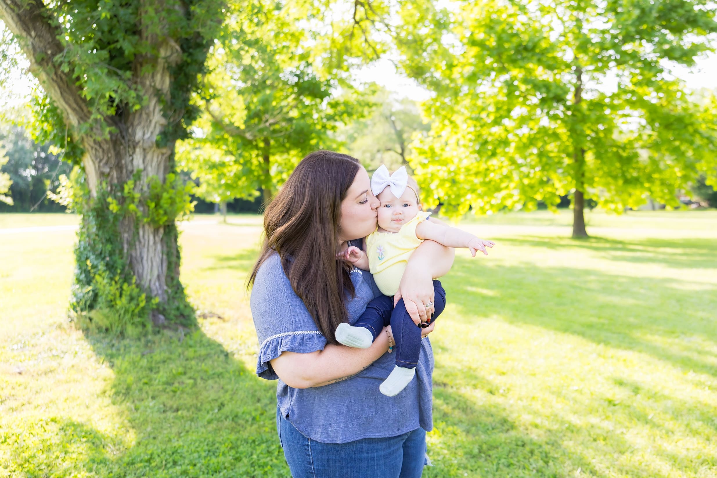 Mom kissing baby during stress free mom and me photoshoot in pittsburg ks