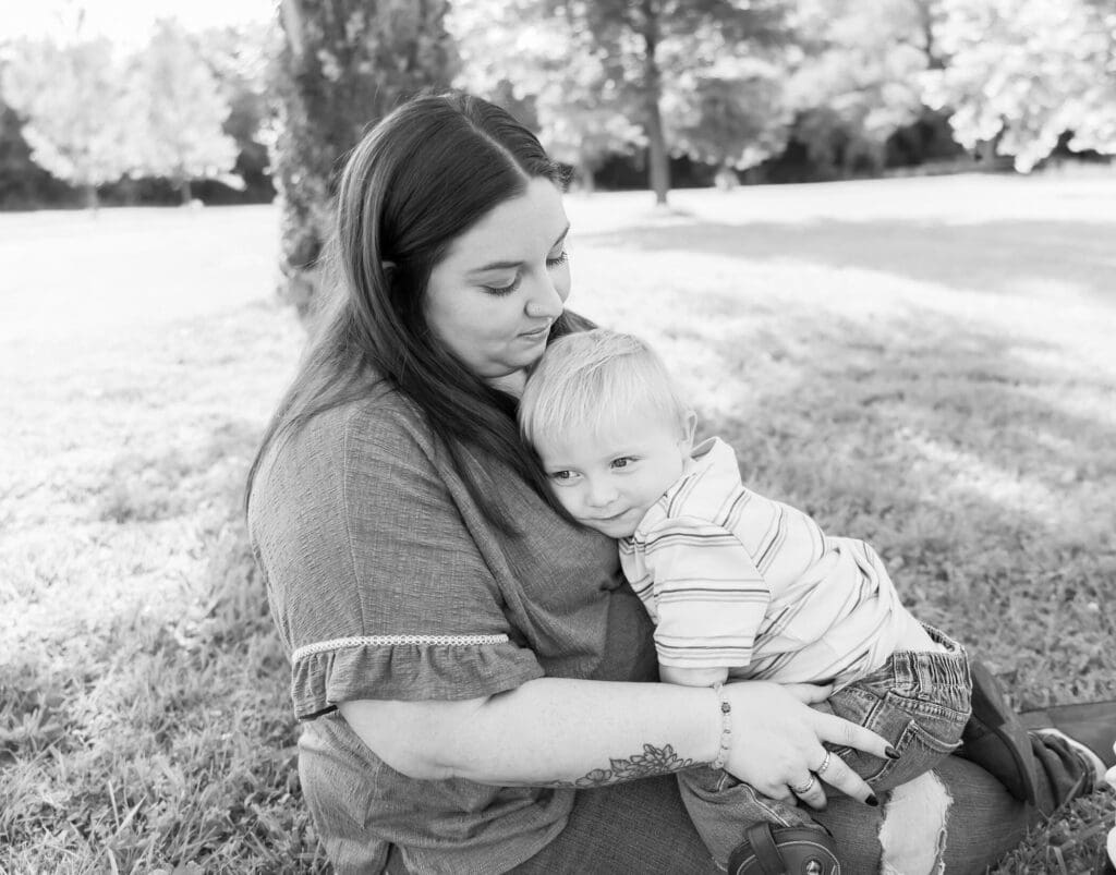 Mom snuggling toddler during stress free mom and me photoshoot in joplin mo