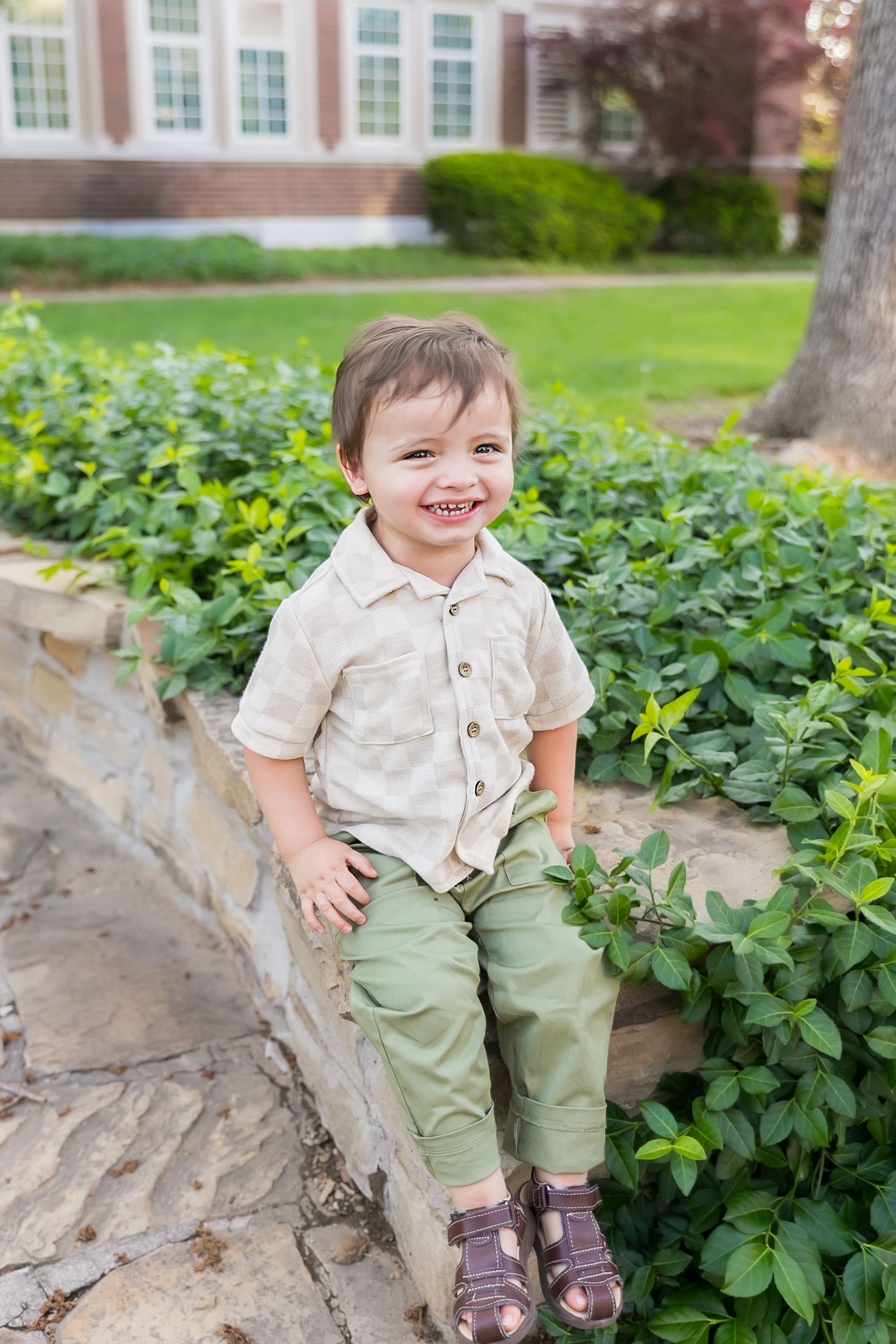 Two-year-old boy smiling during an outdoor birthday photography session