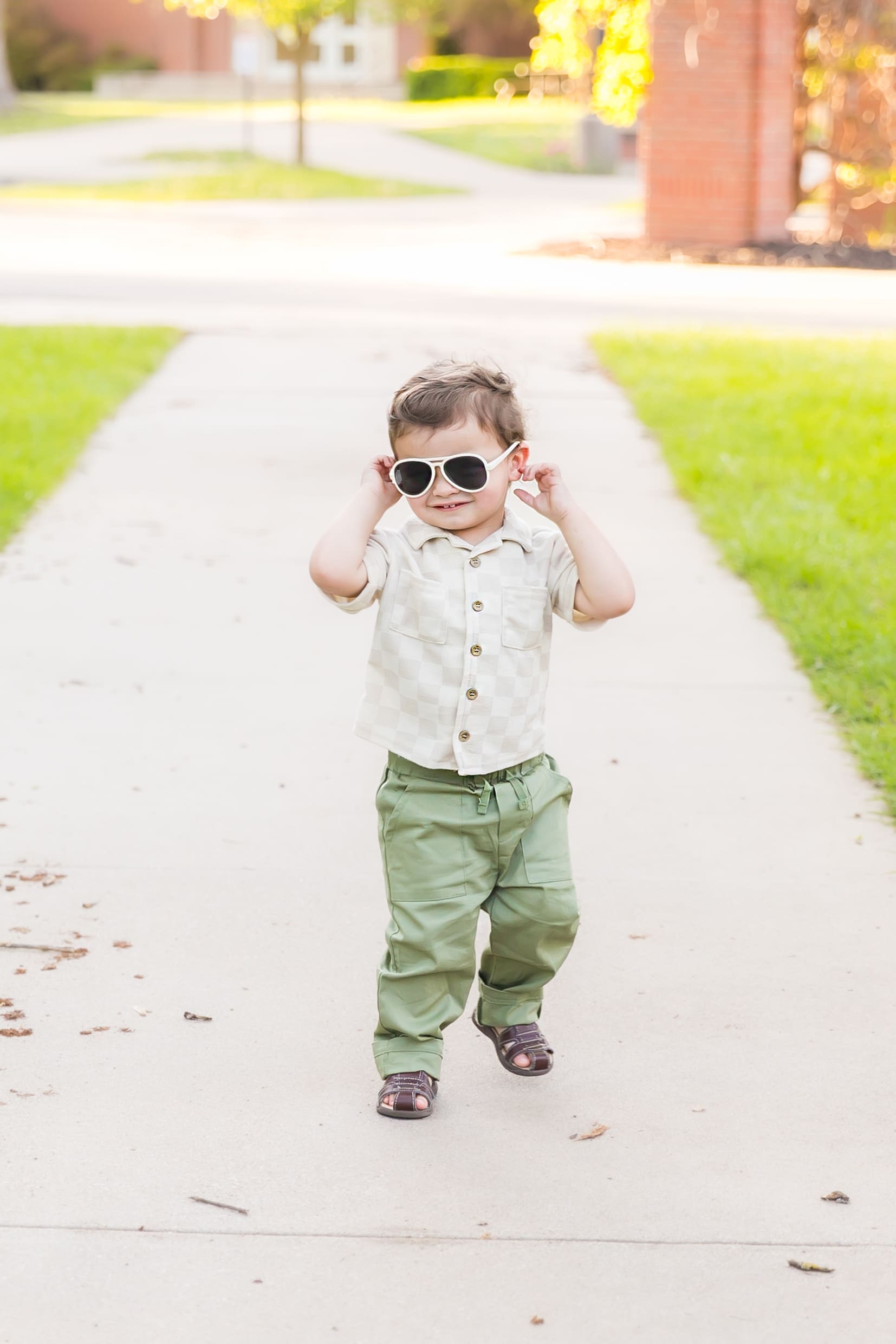 Two-year-old boy wearing sunglasses during his birthday photoshoot