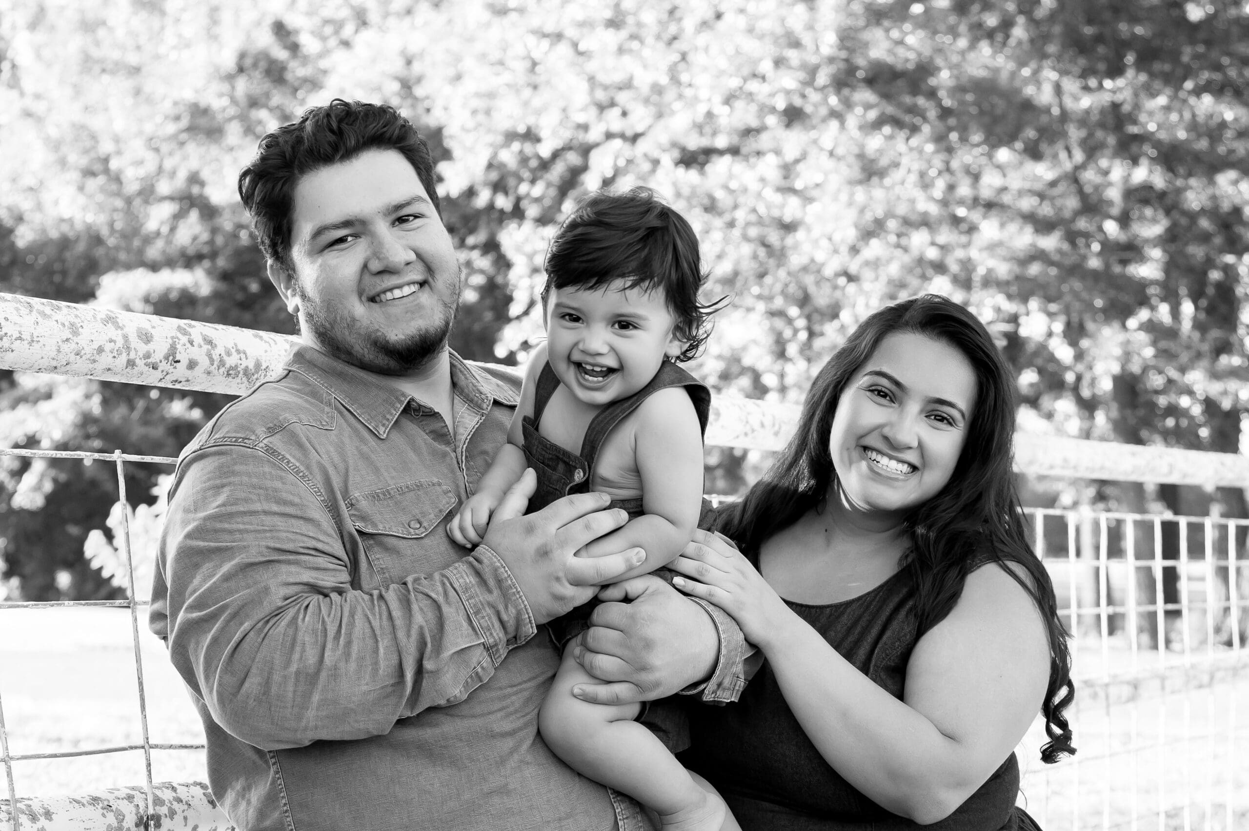 parents laughing with baby during fun stress free family photoshoot in pittsburg ks