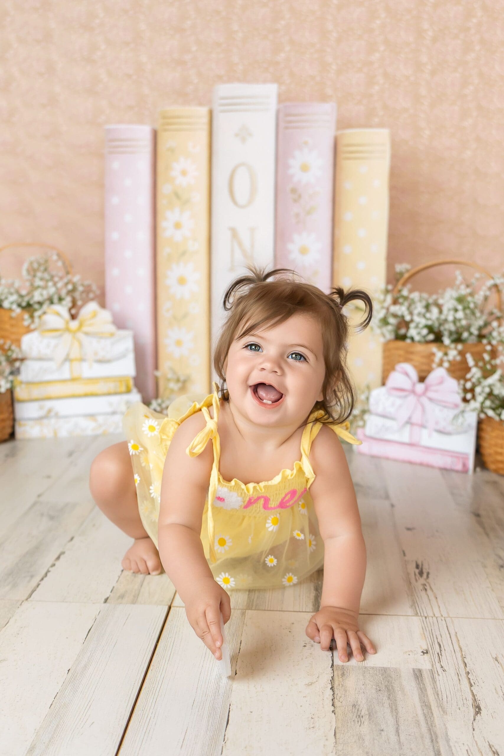 Creative first birthday photography featuring a custom backdrop and decorations in joplin mo