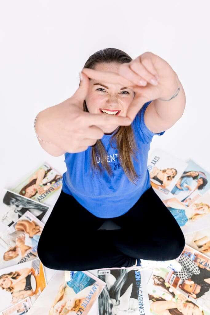 Small business owner posing with papers of past clients from increase ROI of brand photoshoot in pittsburg ks