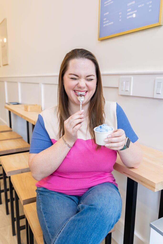 brand photography session showing small business owner cheesing with ice cream in joplin mo
